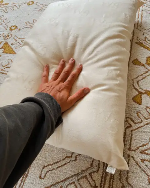 Sol Brah’s hand pressing a Woolshire wool pillow