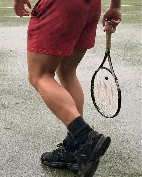 Sol Brah on a tennis court in black WYDE shoes